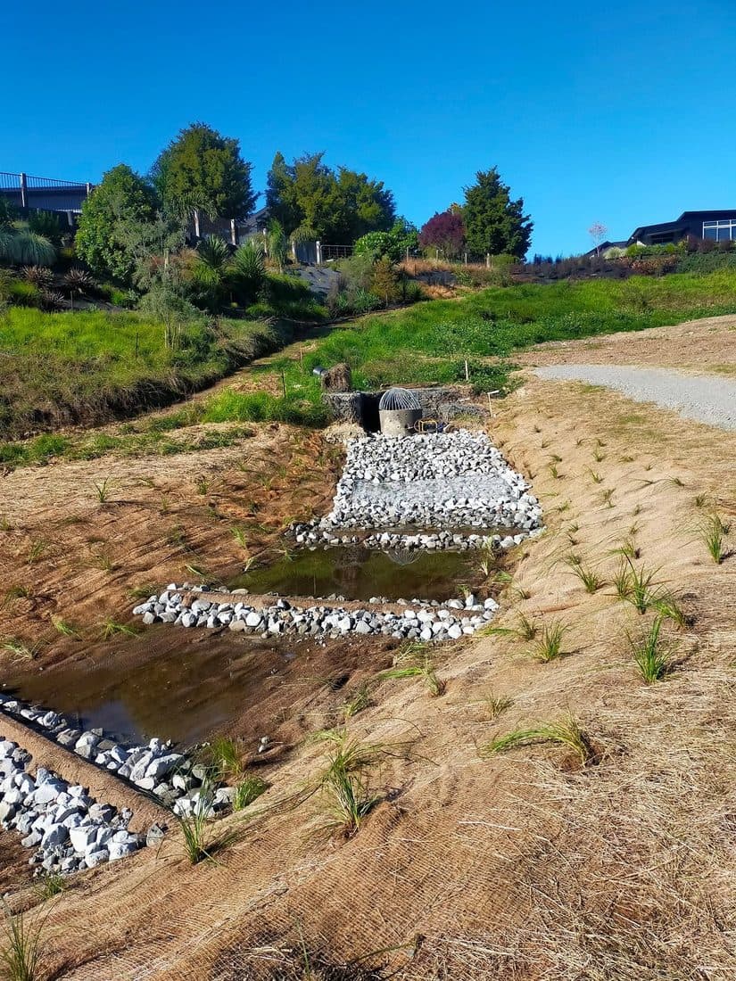 Rock armour laid across a shaped earth bank on a new subdivision